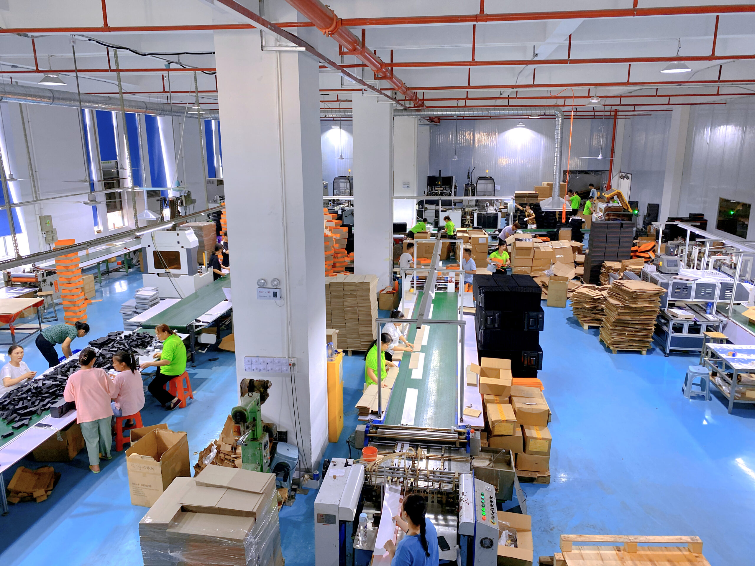 A factory floor with workers and machines creating POP displays