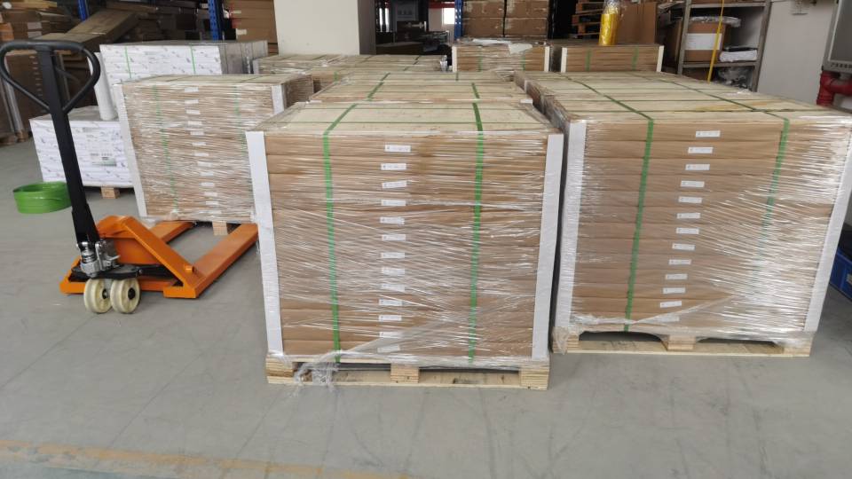 A flat-packed cardboard display next to its assembled version