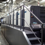 Modern offset printing press machine in print house.