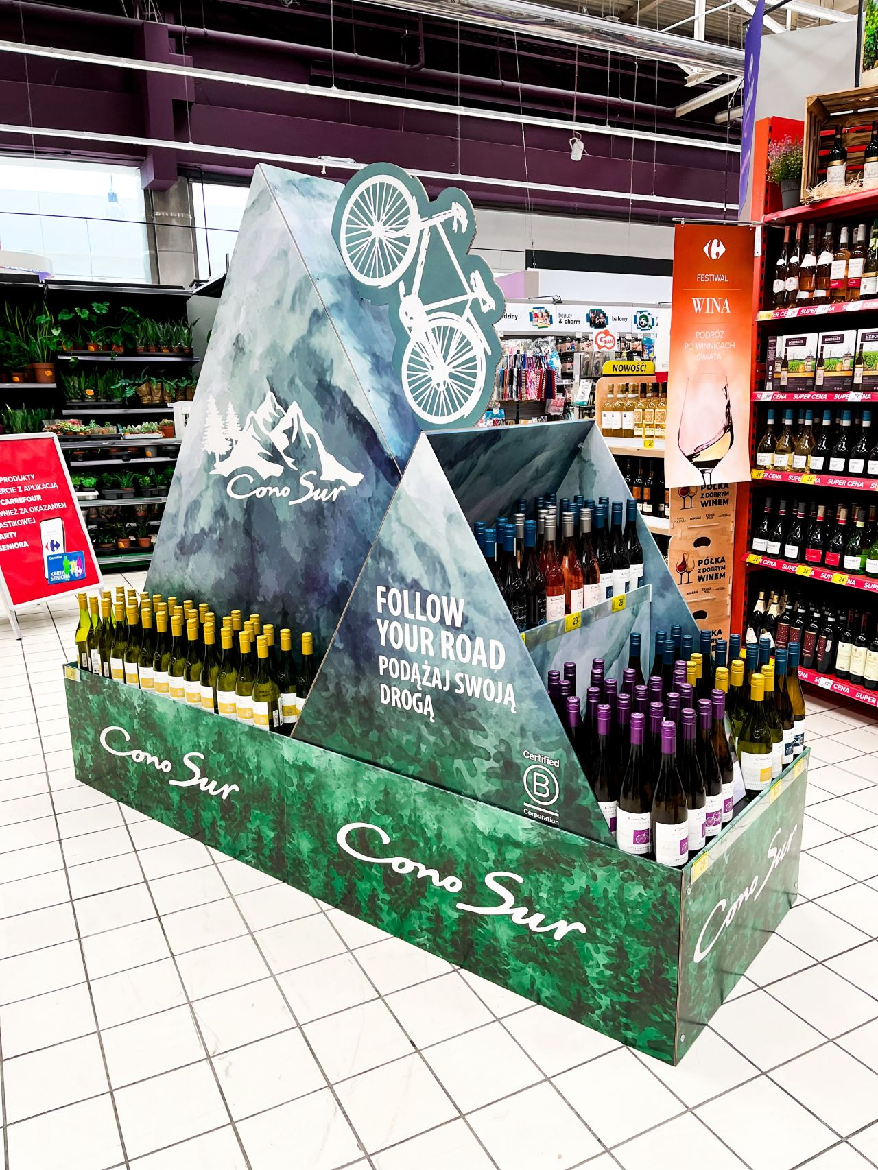 A collection of [custom cardboard displays](https://leader-display.com/the-ultimate-guide-to-cardboard-displays-with-hooks-maximizing-retail-space-and-sales/)[^1] in a bright retail environment.