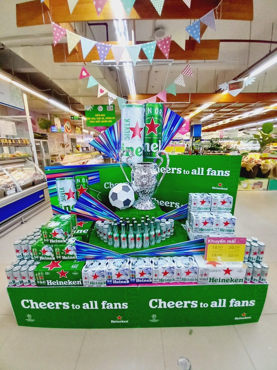 A large pallet display of soda in a grocery store aisle