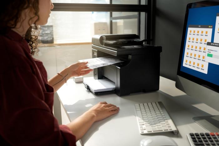 A small thermal printer outputting a black and white sales receipt at a point-of-sale terminal