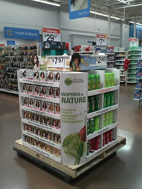 A custom cardboard display stand in a retail store setting.