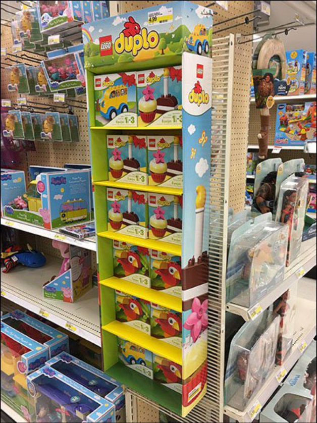 A standard single-faced cardboard sidekick display next to a retail endcap