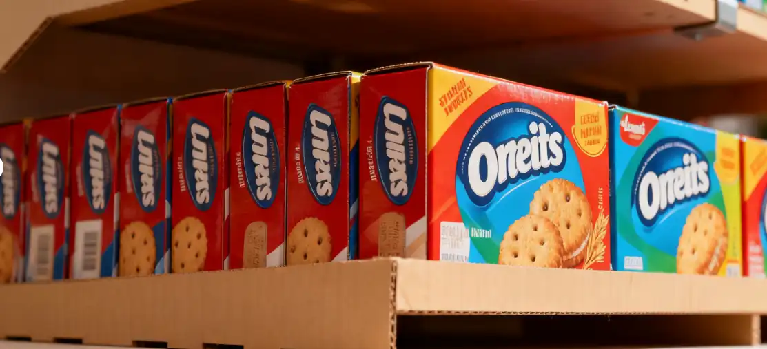 A close-up shot showing the detailed printing and sturdy shelves of a cardboard display, holding cookie boxes securely.