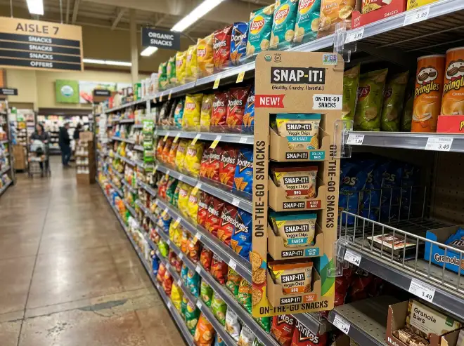 cardboard sidekick display sample attached to aisle shelf with small products