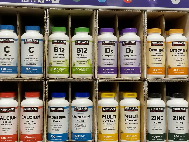 Close-up of supplement bottles in individual corrugated compartments with labels facing forward