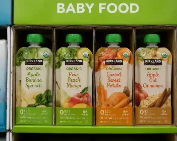 Close-up of baby food pouches in individual compartments on the top layer of a Costco pallet display