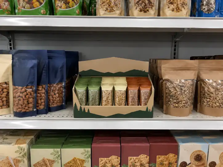 A PDQ display on a grocery shelf showing the clearance above and side positioning relative to adjacent products