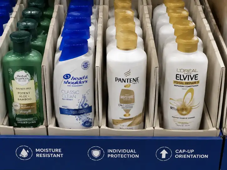 Close-up of shampoo and conditioner bottles in individual moisture-resistant compartments with cap-up orientation