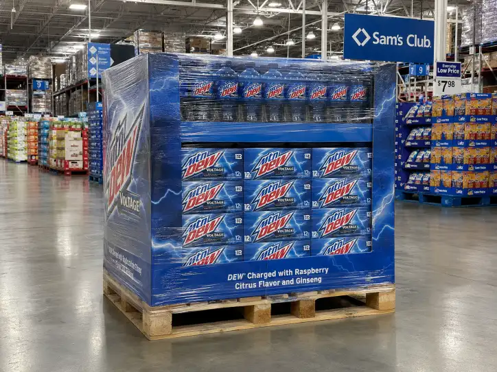 Sam's Club warehouse aisle with a branded pallet display on a 9-block GMA pallet, shrink-wrapped with visible product