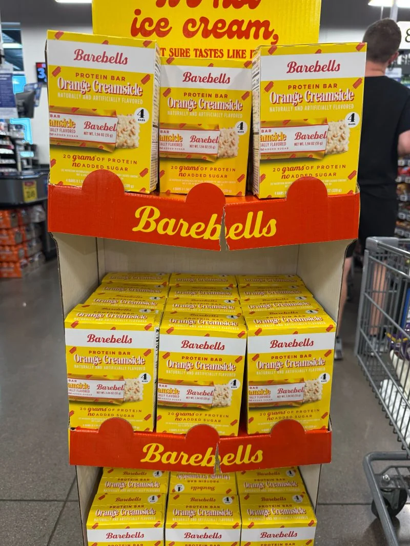 Loaded cardboard retail display showing tray front bonding joints